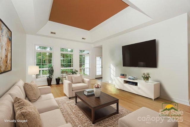 14831 Charterhouse Ln, Huntersville, NC 28078 - living area with a raised ceiling, light wood-style floors, and baseboards