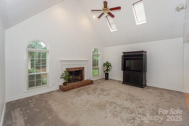 14831 Charterhouse Ln, Huntersville, NC 28078 - unfurnished living room featuring high vaulted ceiling, a skylight, a ceiling fan, plenty of natural light, and a brick fireplace