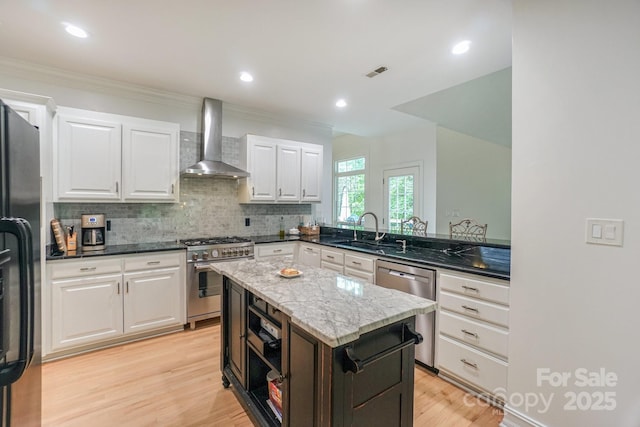14831 Charterhouse Ln, Huntersville, NC 28078 - kitchen with wall chimney exhaust hood, stainless steel appliances, a sink, light wood-style flooring, and decorative backsplash