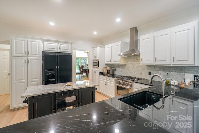 14831 Charterhouse Ln, Huntersville, NC 28078 - kitchen featuring appliances with stainless steel finishes, wall chimney range hood, ornamental molding, backsplash, and dark stone countertops