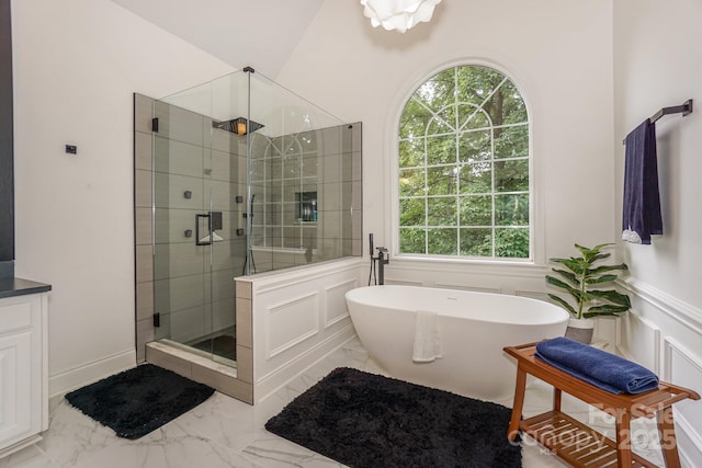 14831 Charterhouse Ln, Huntersville, NC 28078 - bathroom featuring a shower stall, marble finish floors, plenty of natural light, a freestanding bath, and a decorative wall