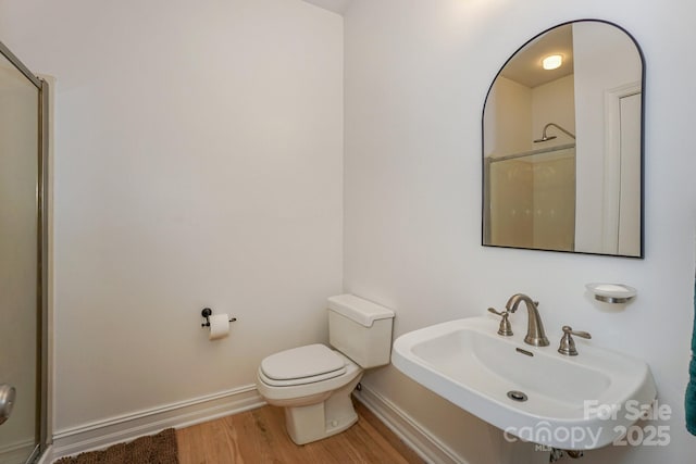 14831 Charterhouse Ln, Huntersville, NC 28078 - bathroom with a sink, wood finished floors, a shower, baseboards, and toilet
