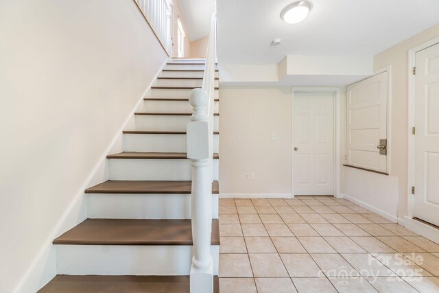 64 Mclain St, Asheville, NC 28803 - stairs featuring tile patterned flooring and baseboards