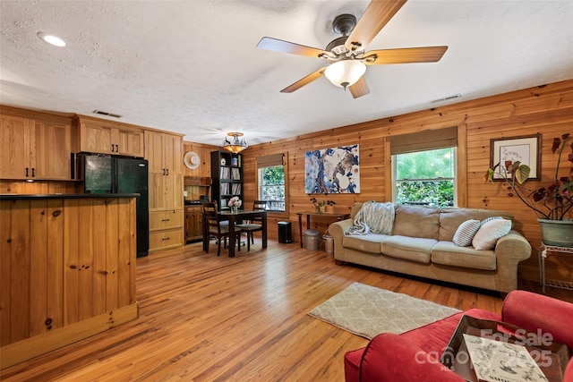 823 Turtle Creek Rd, Sylva, NC 28779 - living room with light wood-style floors, ceiling fan, wooden walls, a textured ceiling, and recessed lighting