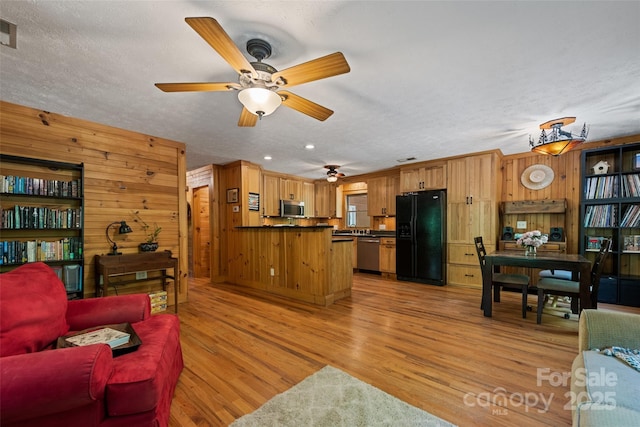 823 Turtle Creek Rd, Sylva, NC 28779 - living area featuring wooden walls, light wood-type flooring, a ceiling fan, a textured ceiling, and recessed lighting