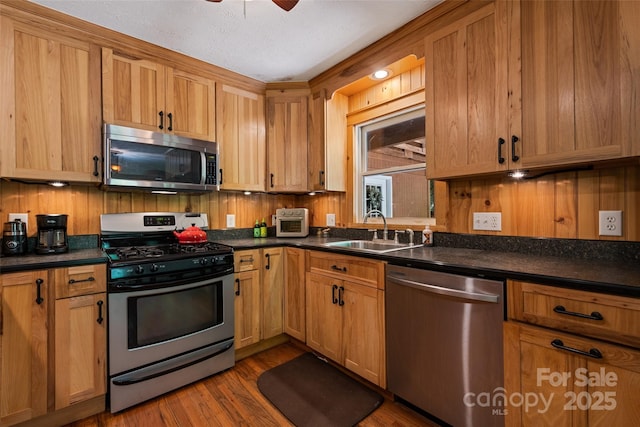 823 Turtle Creek Rd, Sylva, NC 28779 - kitchen with appliances with stainless steel finishes, a sink, dark countertops, and dark wood finished floors