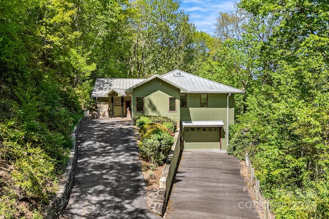1760 Winding Creek Dr, Waynesville, NC 28786 - view of front facade featuring driveway, metal roof, a standing seam roof, and a garage