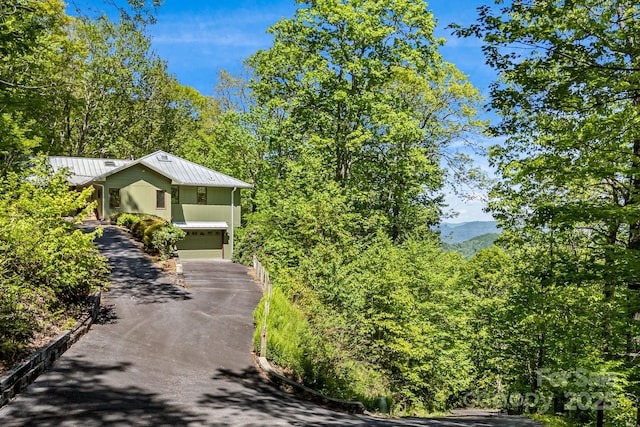 1760 Winding Creek Dr, Waynesville, NC 28786 - view of front of house with asphalt driveway, metal roof, an attached garage, and a standing seam roof
