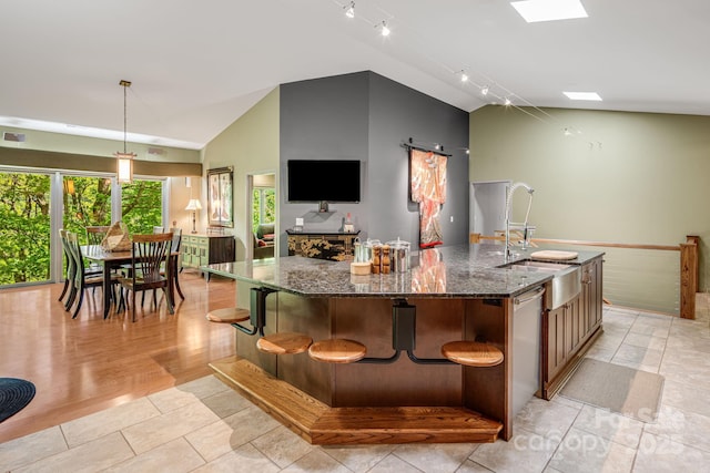 1760 Winding Creek Dr, Waynesville, NC 28786 - kitchen with lofted ceiling, a sink, a spacious island, dark stone counters, and track lighting