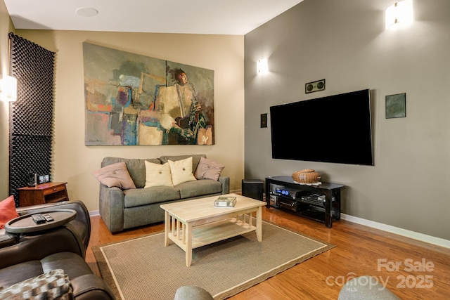 1760 Winding Creek Dr, Waynesville, NC 28786 - living room featuring wood finished floors, baseboards, and lofted ceiling