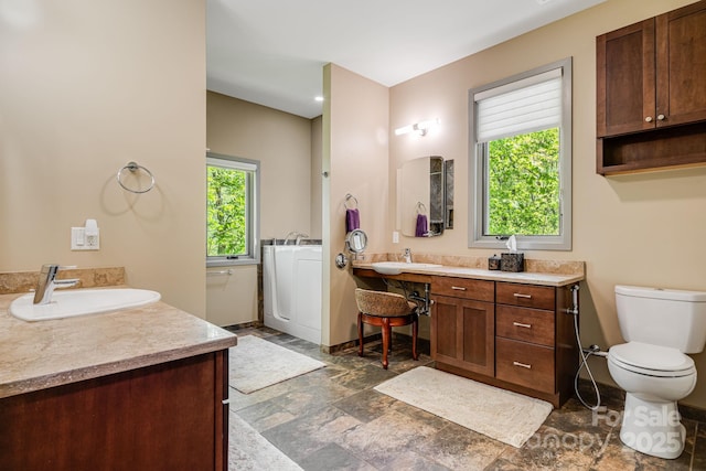 1760 Winding Creek Dr, Waynesville, NC 28786 - bathroom featuring vanity, toilet, stone finish floors, and baseboards