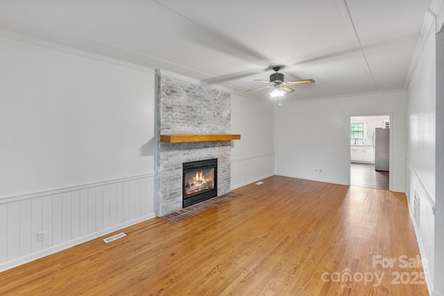 956 Stony Point Rd, Kings Mountain, NC 28086 - unfurnished living room featuring crown molding, wood finished floors, a brick fireplace, and ceiling fan