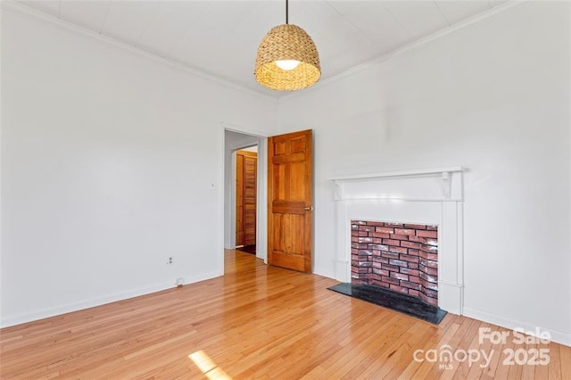 956 Stony Point Rd, Kings Mountain, NC 28086 - unfurnished living room featuring hardwood / wood-style floors, a fireplace with raised hearth, ornamental molding, and baseboards