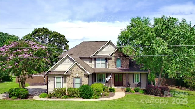 141 Weathers Creek Rd, Troutman, NC 28166 - view of front facade featuring a front lawn, brick siding, and covered porch