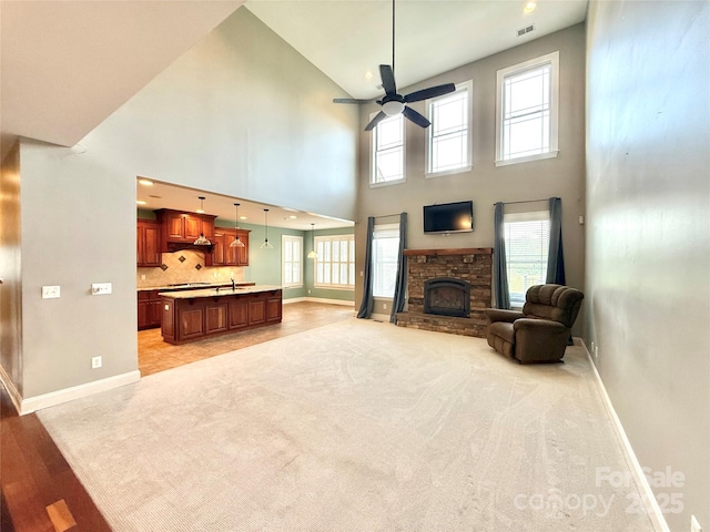 141 Weathers Creek Rd, Troutman, NC 28166 - living area with a high ceiling, a stone fireplace, and ceiling fan