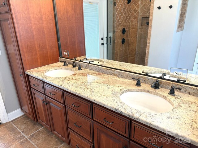 141 Weathers Creek Rd, Troutman, NC 28166 - bathroom featuring double vanity, a tile shower, and tile patterned floors