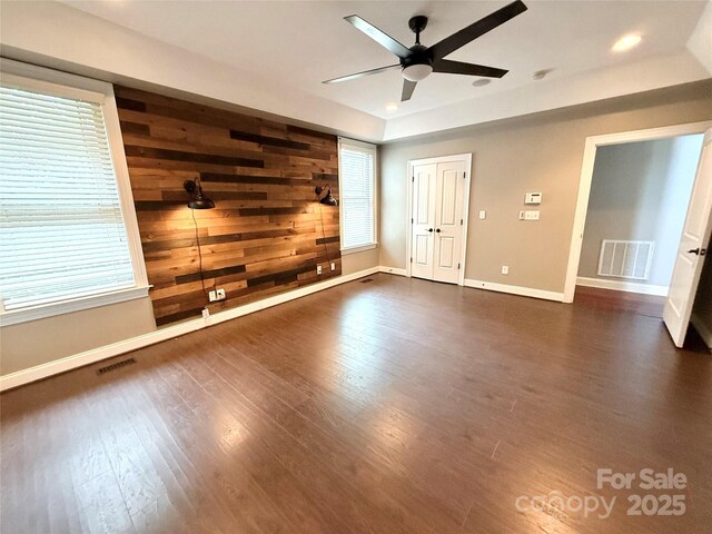 141 Weathers Creek Rd, Troutman, NC 28166 - unfurnished bedroom featuring dark wood finished floors, recessed lighting, a tray ceiling, and ceiling fan