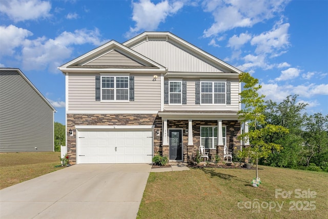 347 Carolina Hemlock Dr, Locust, NC 28097 - craftsman house with stone siding, a front lawn, an attached garage, and a porch