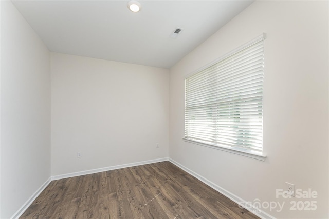 347 Carolina Hemlock Dr, Locust, NC 28097 - spare room featuring dark wood-style flooring and baseboards