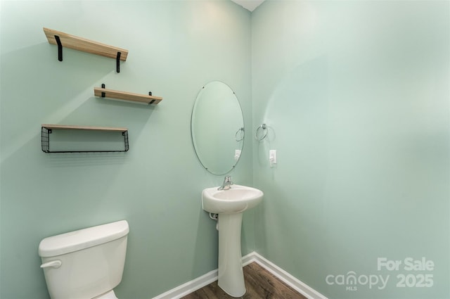 347 Carolina Hemlock Dr, Locust, NC 28097 - bathroom featuring wood finished floors, toilet, baseboards, and a sink