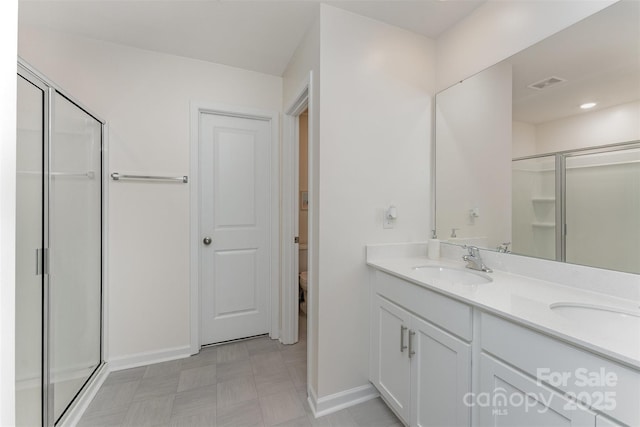 347 Carolina Hemlock Dr, Locust, NC 28097 - bathroom featuring double vanity, a shower stall, baseboards, and tile patterned floors