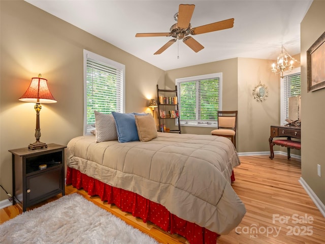 117 Eagles Crest Way, Lake Lure, NC 28746 - bedroom with multiple windows, light wood-style floors, baseboards, and a chandelier