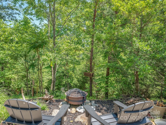 117 Eagles Crest Way, Lake Lure, NC 28746 - view of patio with a fire pit, area for grilling, and a forest view