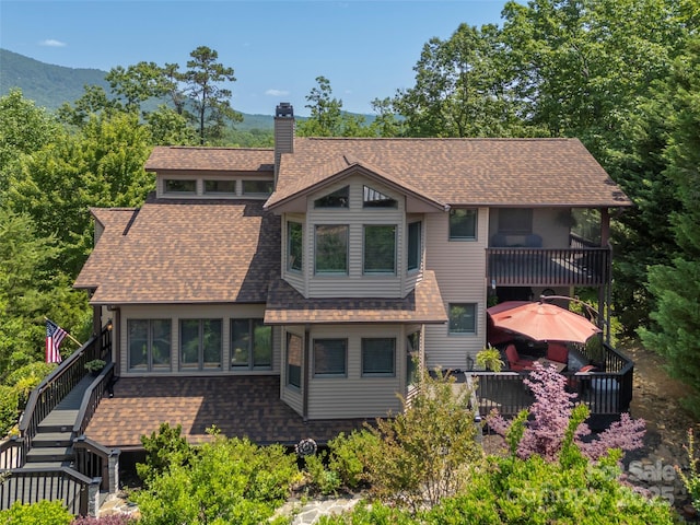 117 Eagles Crest Way, Lake Lure, NC 28746 - view of front of property featuring a balcony, a shingled roof, a chimney, stairs, and a mountain view