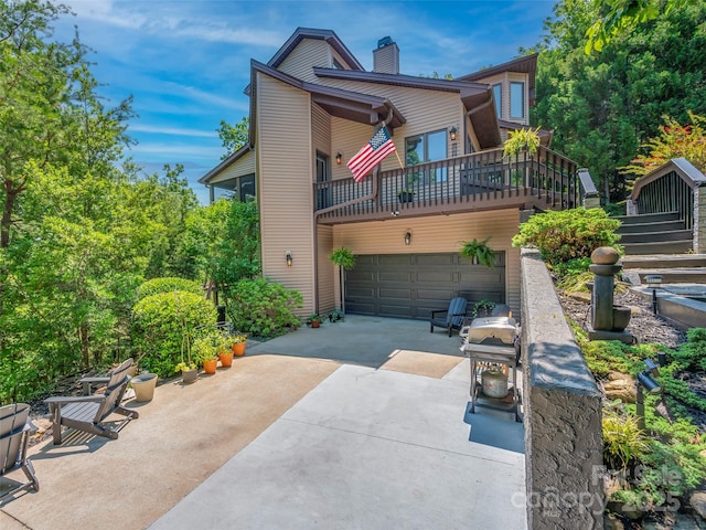 117 Eagles Crest Way, Lake Lure, NC 28746 - view of front of property with driveway, an attached garage, and a chimney
