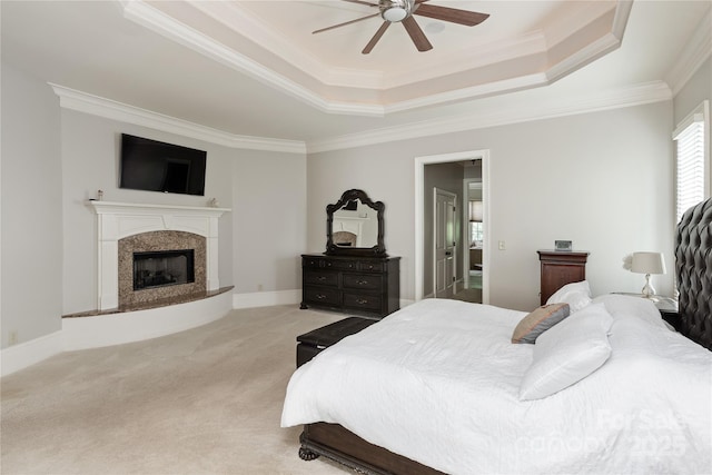1032 Seminole Dr, Waxhaw, NC 28173 - bedroom with a tray ceiling, ornamental molding, light colored carpet, a premium fireplace, and ceiling fan