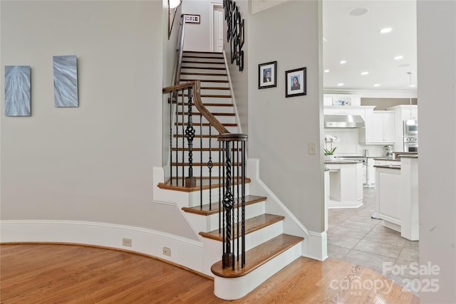 1032 Seminole Dr, Waxhaw, NC 28173 - stairway with wood finished floors, recessed lighting, and ornamental molding