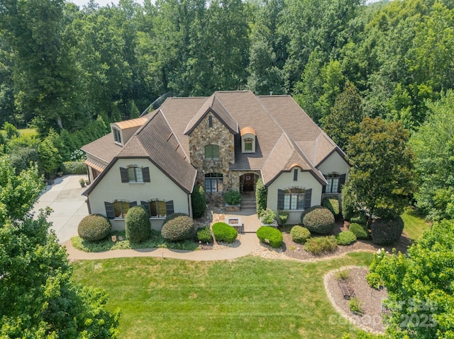1032 Seminole Dr, Waxhaw, NC 28173 - french country style house featuring stone siding, a front yard, a shingled roof, and stucco siding