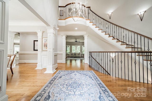 1032 Seminole Dr, Waxhaw, NC 28173 - foyer entrance with wood finished floors, ornate columns, a towering ceiling, ceiling fan, and ornamental molding
