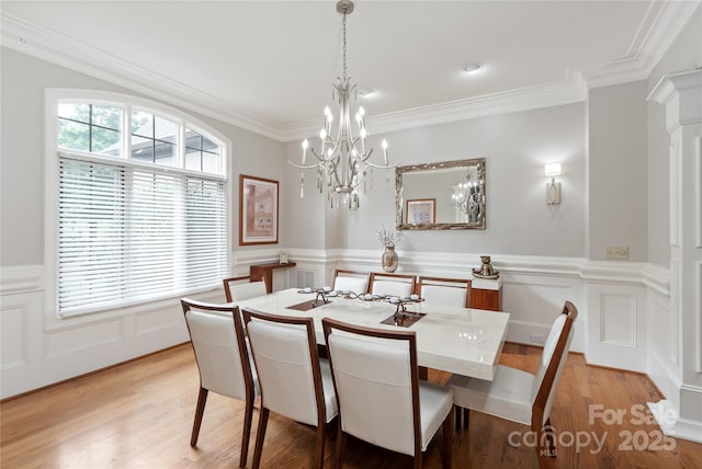1032 Seminole Dr, Waxhaw, NC 28173 - dining area with a chandelier, ornamental molding, light wood-type flooring, a wainscoted wall, and a decorative wall