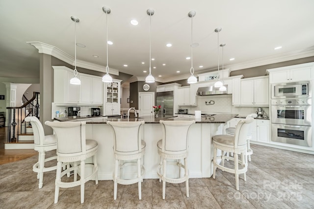 1032 Seminole Dr, Waxhaw, NC 28173 - kitchen with built in appliances, tasteful backsplash, crown molding, ventilation hood, and a kitchen breakfast bar