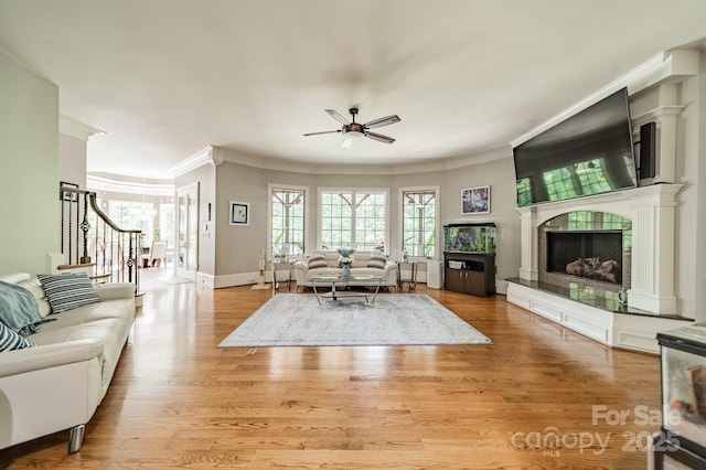 1032 Seminole Dr, Waxhaw, NC 28173 - living room with crown molding, ceiling fan, a fireplace, plenty of natural light, and wood finished floors