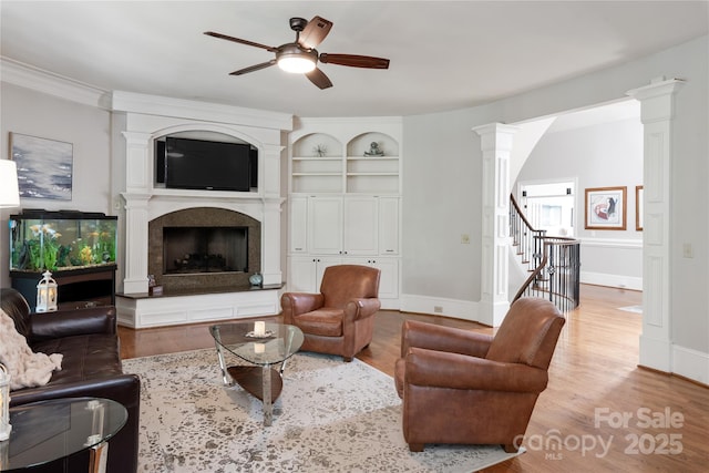 1032 Seminole Dr, Waxhaw, NC 28173 - living area with a ceiling fan, wood finished floors, ornate columns, and a high end fireplace