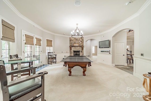 1032 Seminole Dr, Waxhaw, NC 28173 - rec room with arched walkways, crown molding, carpet, a chandelier, and a fireplace