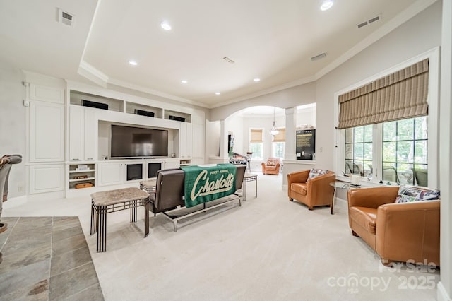 1032 Seminole Dr, Waxhaw, NC 28173 - living room featuring arched walkways, ornamental molding, recessed lighting, light carpet, and ornate columns