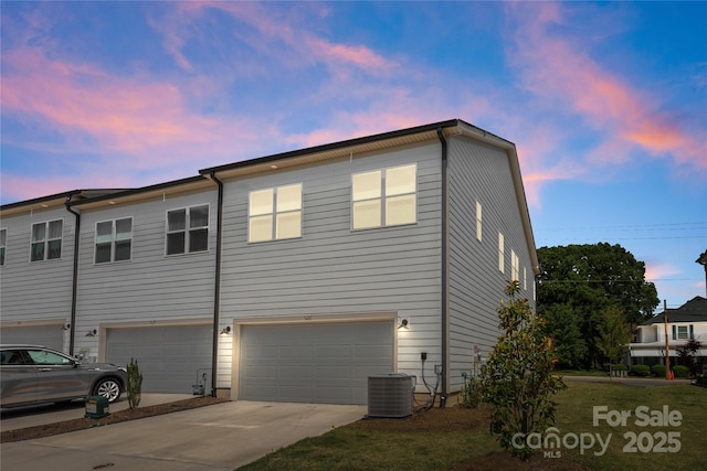 5481 Comiskey Aly, Kannapolis, NC 28081 - property exterior at dusk featuring an attached garage, driveway, and central air condition unit