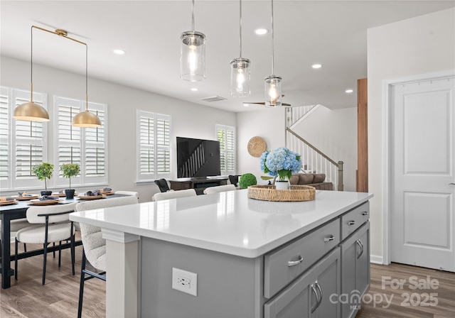 5481 Comiskey Aly, Kannapolis, NC 28081 - kitchen featuring gray cabinets, light countertops, a center island, wood finished floors, and recessed lighting