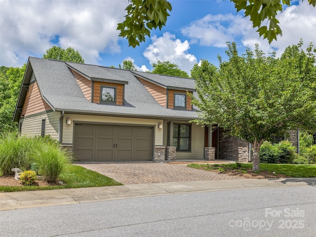 207 Hogans View Cir, Hendersonville, NC 28739 - view of front of house with stone siding, an attached garage, a porch, decorative driveway, and roof with shingles