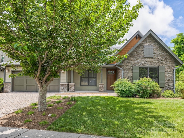 207 Hogans View Cir, Hendersonville, NC 28739 - craftsman-style house featuring stone siding, a front lawn, driveway, and covered porch