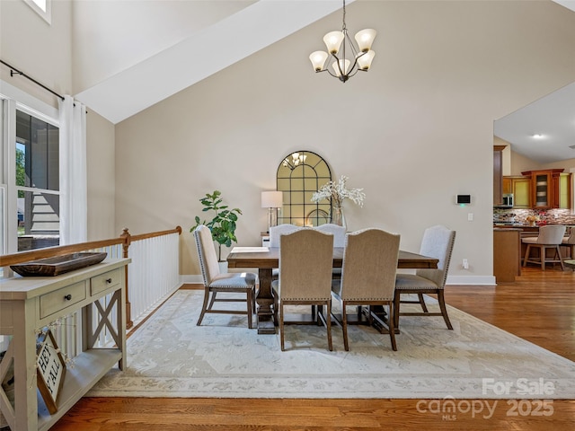 207 Hogans View Cir, Hendersonville, NC 28739 - dining room with high vaulted ceiling, a chandelier, and wood finished floors