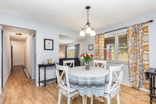 2210 Joes Lake Rd, Shelby, NC 28152 - dining room with attic access, light wood-type flooring, baseboards, and a chandelier