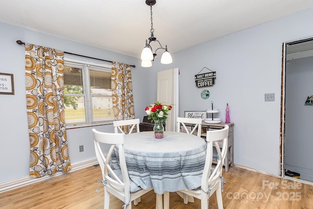 2210 Joes Lake Rd, Shelby, NC 28152 - dining room featuring a chandelier, light wood-style flooring, and baseboards