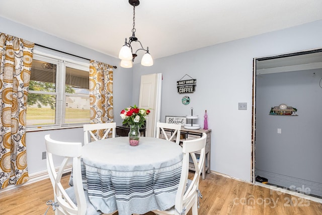 2210 Joes Lake Rd, Shelby, NC 28152 - dining room with light wood-style floors and a chandelier