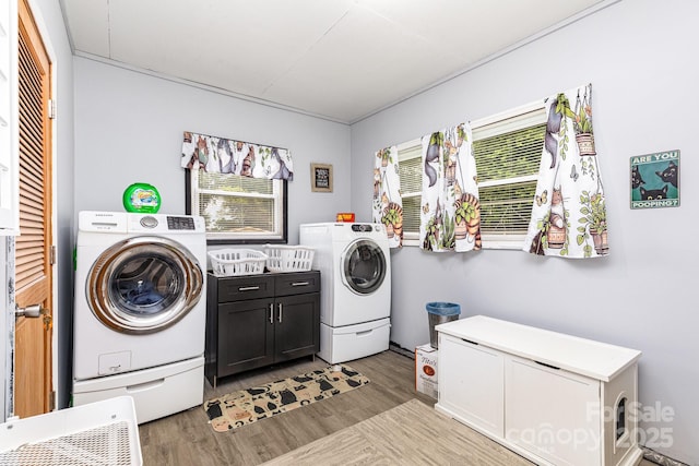 2210 Joes Lake Rd, Shelby, NC 28152 - laundry room with cabinet space, light wood finished floors, and washer and clothes dryer