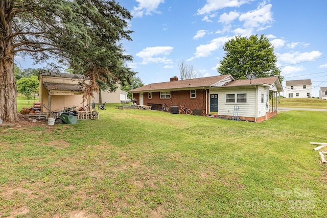 2210 Joes Lake Rd, Shelby, NC 28152 - back of house with a lawn, a chimney, and central AC