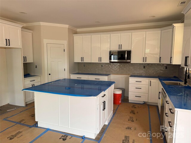 2589 Polo Ln, Maiden, NC 28650 - kitchen with appliances with stainless steel finishes, a sink, dark countertops, crown molding, and backsplash